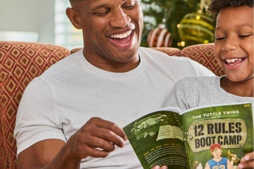 Father and child reading Tuttle Twins book together during homeschool learning time at home.