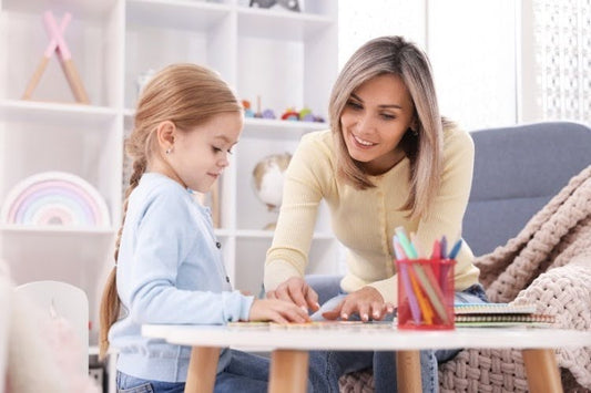Mother helping daughter with an elementary homeschool lesson.
