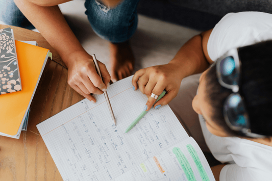 Parent helping child with homeschool math lessons at home in Iowa.
