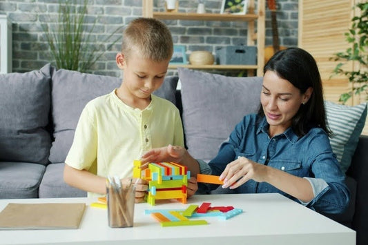 Mother teaching her son through a hands-on homeschool activity.