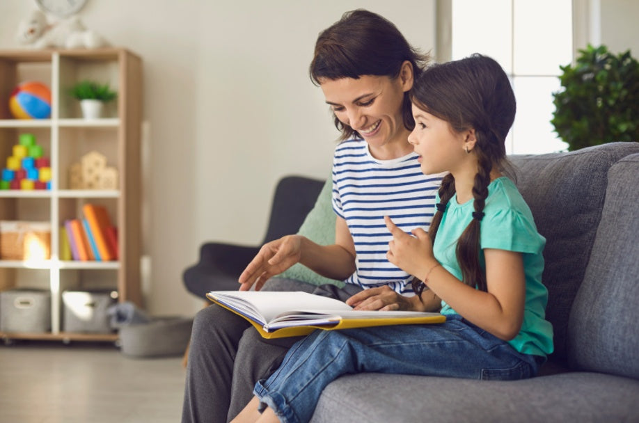 Parent reading with child during homeschool learning at home.