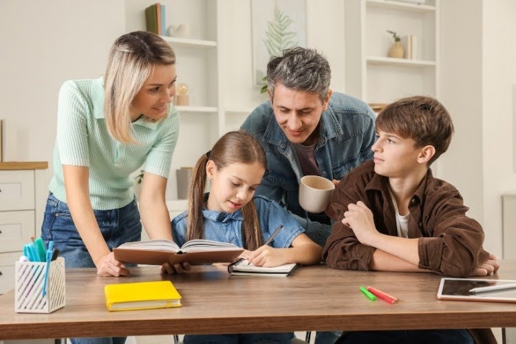 Parents helping children follow their homeschool schedule at home.