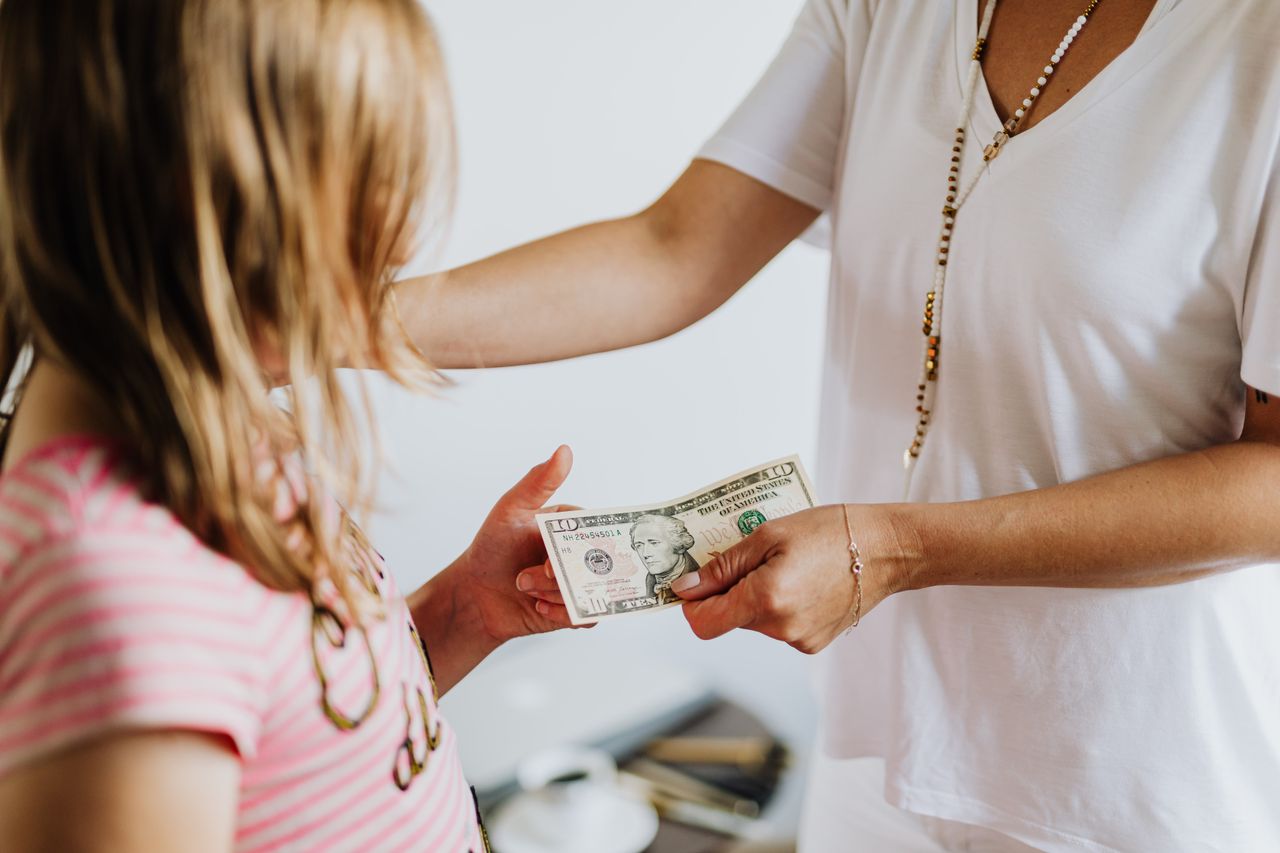 A mother teaching her daughter about money