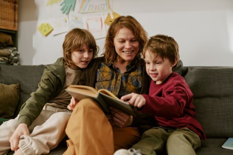 Mother reading classic literature with her children.